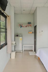Postel nebo postele na pokoji v ubytování ไร่นภาดลรีสอร์ท