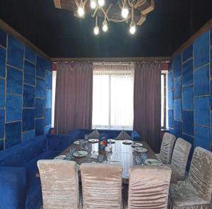 a dining room with a table and chairs at 7Jol Hotel in Khatynkopir
