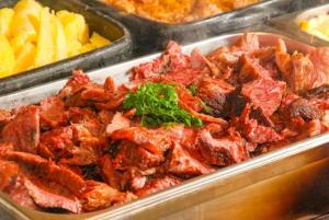 バレトスにあるBarretos Thermas Resortの肉とフライドポテトのトレイ