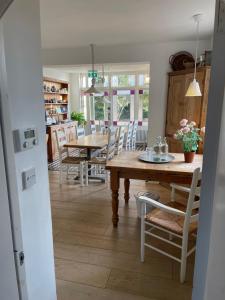 a kitchen and dining room with a table and chairs at Poplars Farm in Henlow