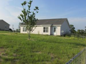 a house in a field with a tree in the yard at Home With View of Columbia Cityscape in Sharpes Hill