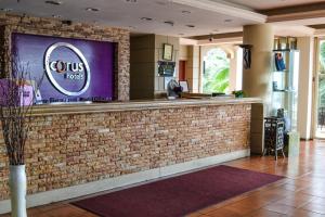 a bar in a restaurant with a brick wall at Corus Paradise Resort Port Dickson in Port Dickson