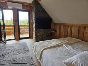 a bedroom with two beds and a large window at Domek LUNA in Olchowiec