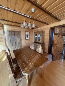 a large wooden table in a room with wooden floors at Guest House Zator in Vyshkiv