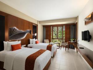 a hotel room with two beds and a television at Nirwana Resort Hotel in Lagoi +134 photos