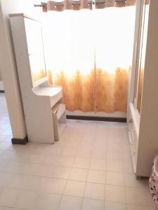 a bathroom with a mirror and a sink and a window at NK hostel P2 16/30 in Ban Song Hong