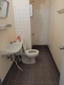 a bathroom with a toilet and a sink at NK hostel P2 16/30 in Ban Song Hong