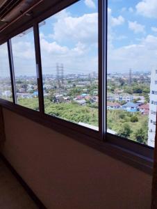 a window with a view of a city at NK hostel P2 16/30 in Ban Song Hong