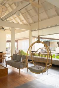 a swing in the living room of a house at Baan Haad Ngam Boutique Resort in Chaweng