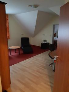 a living room with two chairs and a table at City-Hotel-Pension-Grafenwöhr in Grafenwöhr