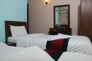 Una cama o camas en una habitación de Hotel Mudkhu Durbar