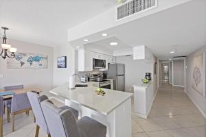 a kitchen and dining room with a table and chairs at Seawinds 706 in Marco Island