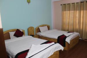 Una cama o camas en una habitación de Hotel Mudkhu Durbar