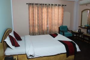 Una cama o camas en una habitación de Hotel Mudkhu Durbar