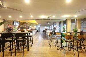 a restaurant with chairs and tables in a room at Pasadena Lodge in Pattaya Central