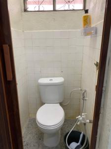 a small bathroom with a toilet and a window at Zahra Homestay in Rantau Panjang