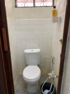 a small bathroom with a toilet and a window at Zahra Homestay in Rantau Panjang +14 photos