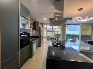 a kitchen with a black counter top in a room at Casa Jurere in Florianópolis