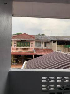 a view of a building from a window at Zahra Homestay in Rantau Panjang
