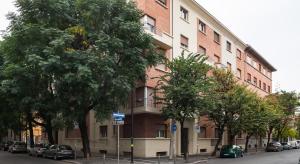 a tall building with cars parked in front of it at Bologna Suite in Bologna