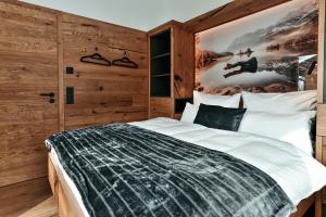 a bedroom with a bed with a poster on the wall at ZSAM Chalets mit Sauna und Hottub in Garmisch-Partenkirchen