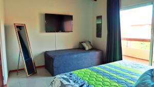 a bedroom with a bed and a flat screen tv at Family-Flexication-Friendly Villa, few steps from Eagle Beach in Palm-Eagle Beach