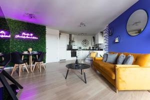a living room with a couch and a table at Jade Apartments Basildon in Basildon