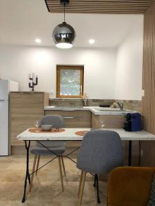 a kitchen with a table and two chairs in it at Le studio Adhémar - parking sur place in Montboucher-sur-Jabron
