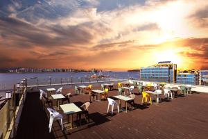 a group of tables and chairs on the deck of a ship at Hotel The Sea Star in Incheon