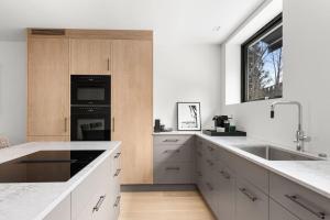a kitchen with a sink and a stove top oven at Fully serviced luxury townhouse near the Vigelandspark in Oslo