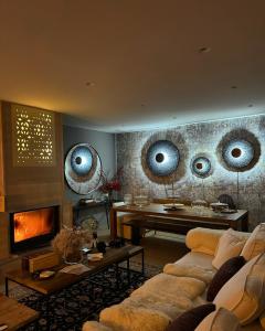 a living room with a couch and a fireplace at Noelle Mountain Suites in Kalavrita