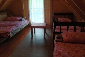 a bedroom with two bunk beds and a window at Mountine cottage Hajdi Komovi in Podgorica