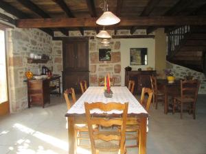 a dining room with a table with a candle on it at Ecuries de Saint Maurice- Maison d'hôtes de Gondou in Lacapelle-Marival