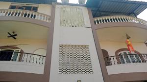 a building with two balconies and a flag on it at Serene Homestay (Mini -For 2 to 3 Guest) in Panaji