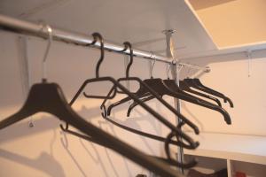 a bunch of black umbrellas hanging from a rack at Modern DIY apartment in Petrikyula