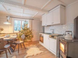 a kitchen with a christmas tree in the middle of it at Strickerl in Bad Goisern