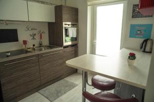 a kitchen with wooden cabinets and a counter top at Modern DIY apartment in Petrikyula