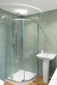 a bathroom with a shower and a sink at Bridge House in Chichester