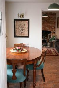 a dining room table with a plate of food on it at Bridge House in Chichester
