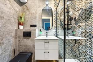 a bathroom with a sink and a mirror at Mikołajska 5 Apartments in Kraków +138 photos