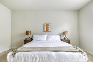 a bedroom with a large white bed with two lamps at Santa Clara 2br w pool balcony elevator gym SFO-1587 in Santa Clara +14 photos
