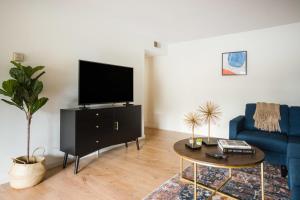 a living room with a blue couch and a tv at Mountain View 1br w balcony pool nr shops SFO-1588 in Mountain View