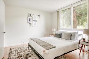 a white bedroom with a large bed and a window at Mountain View 1br w balcony pool nr shops SFO-1588 in Mountain View +8 photos