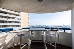 a table and chairs on a balcony with a view of the ocean at Long Beach 2br nr bars groceries beach LAX-1154 in Long Beach