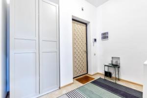 a door in a white room with a rug at Комфортная квартира на ЭКСПО/ Comfortable flat on EXPO in Taldykolʼ