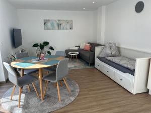 a living room with a table and a couch at Ferienwohnung Ott in Ebbs