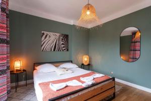 a bedroom with a bed with towels on it at La Messine in Metz