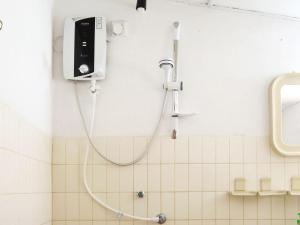 um chuveiro na casa de banho com uma mangueira na parede em Anilau Vila em Hikkaduwa