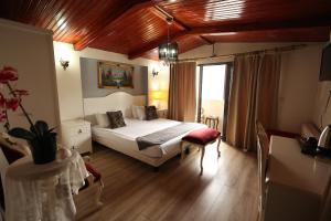 a bedroom with a bed and a table and a window at Asmali Hotel in Istanbul