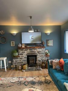 a living room with a couch and a fireplace at 2 bedroom Holiday home near quiet beach in New Quay